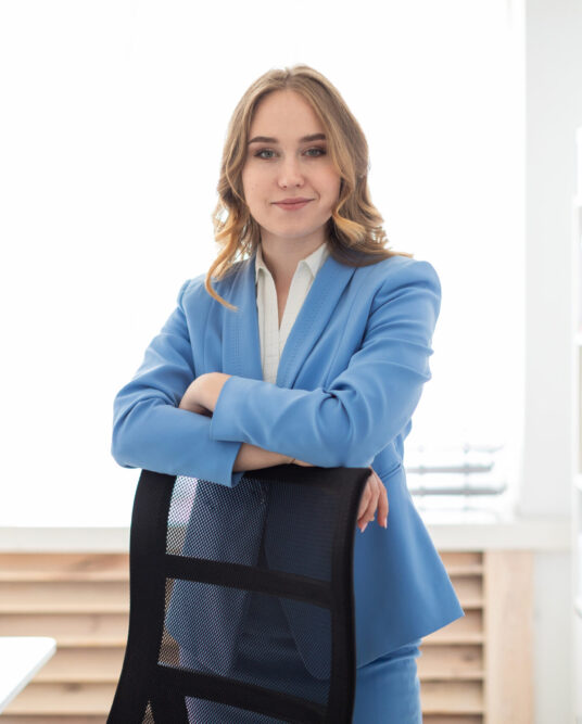 Charming young girl in a blue jacket and white blouse. photo with depth of field